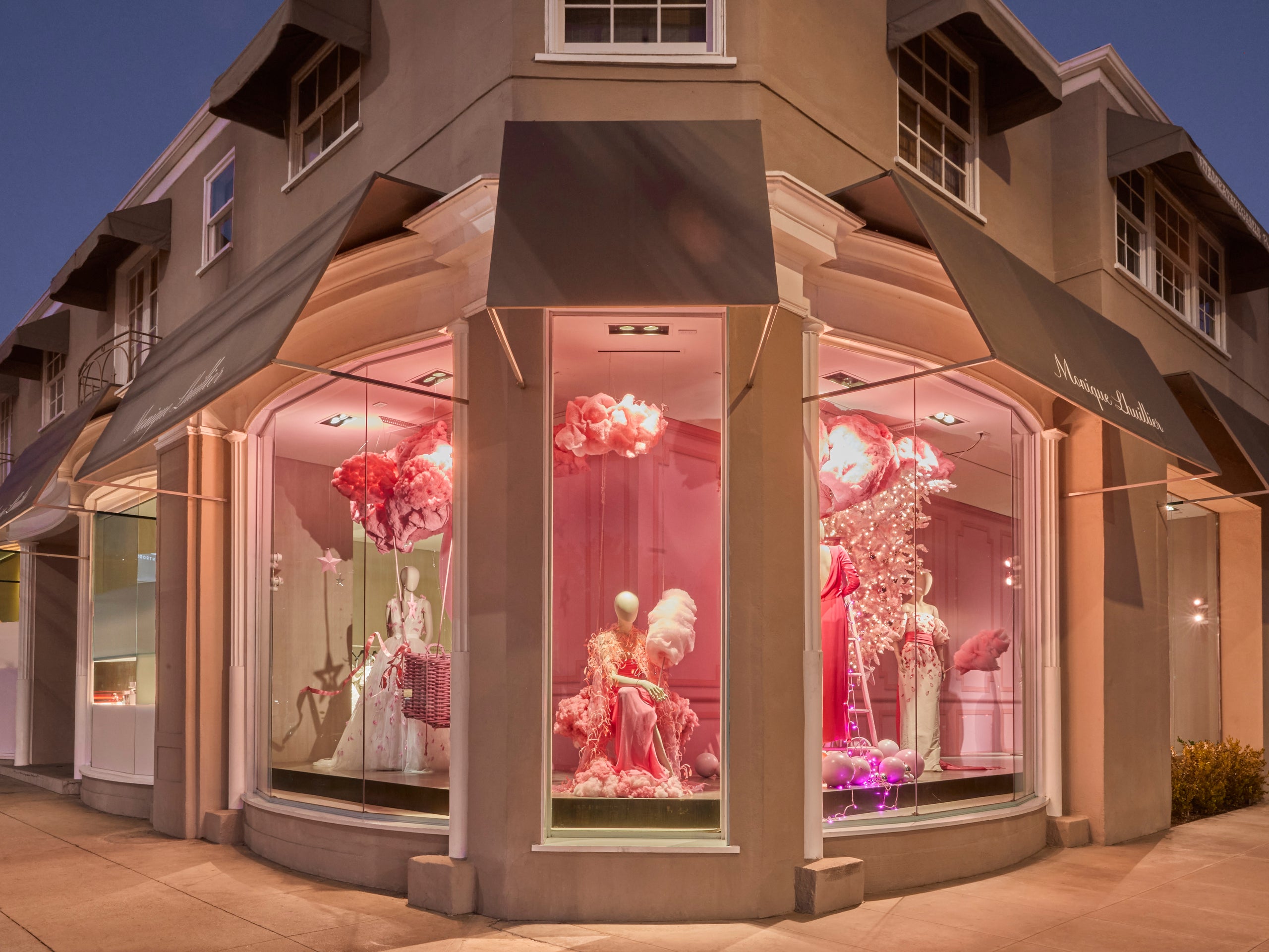 Exterior of Melrose Place flagship store, featuring pink-themed Ready to Wear and an ornate window display with balloons, cotton candy, pink clouds and lights.
