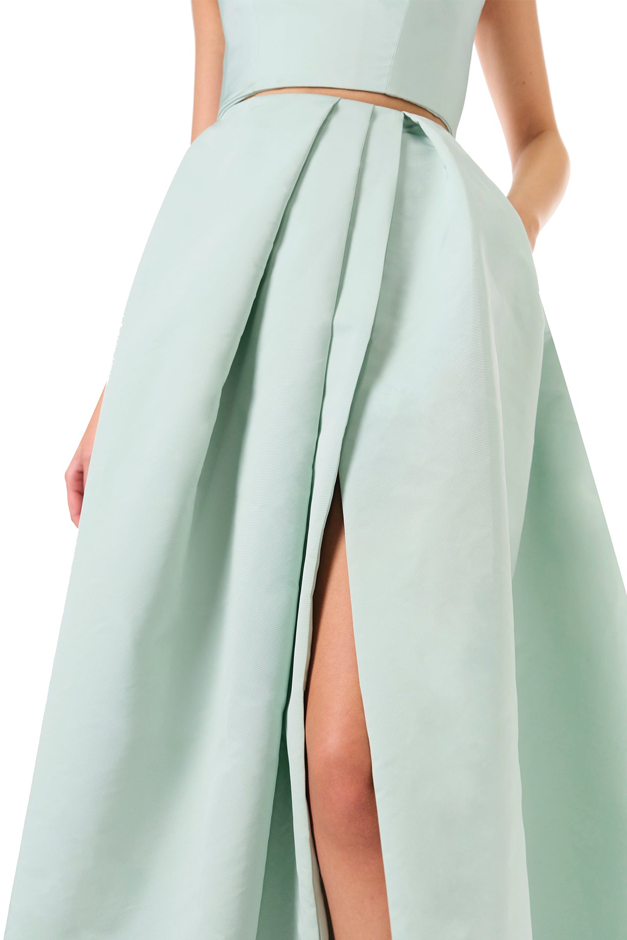 Monique Lhuillier Spring 2023 ball skirt with front slit in pistachio silk faille fabric - slit close up.