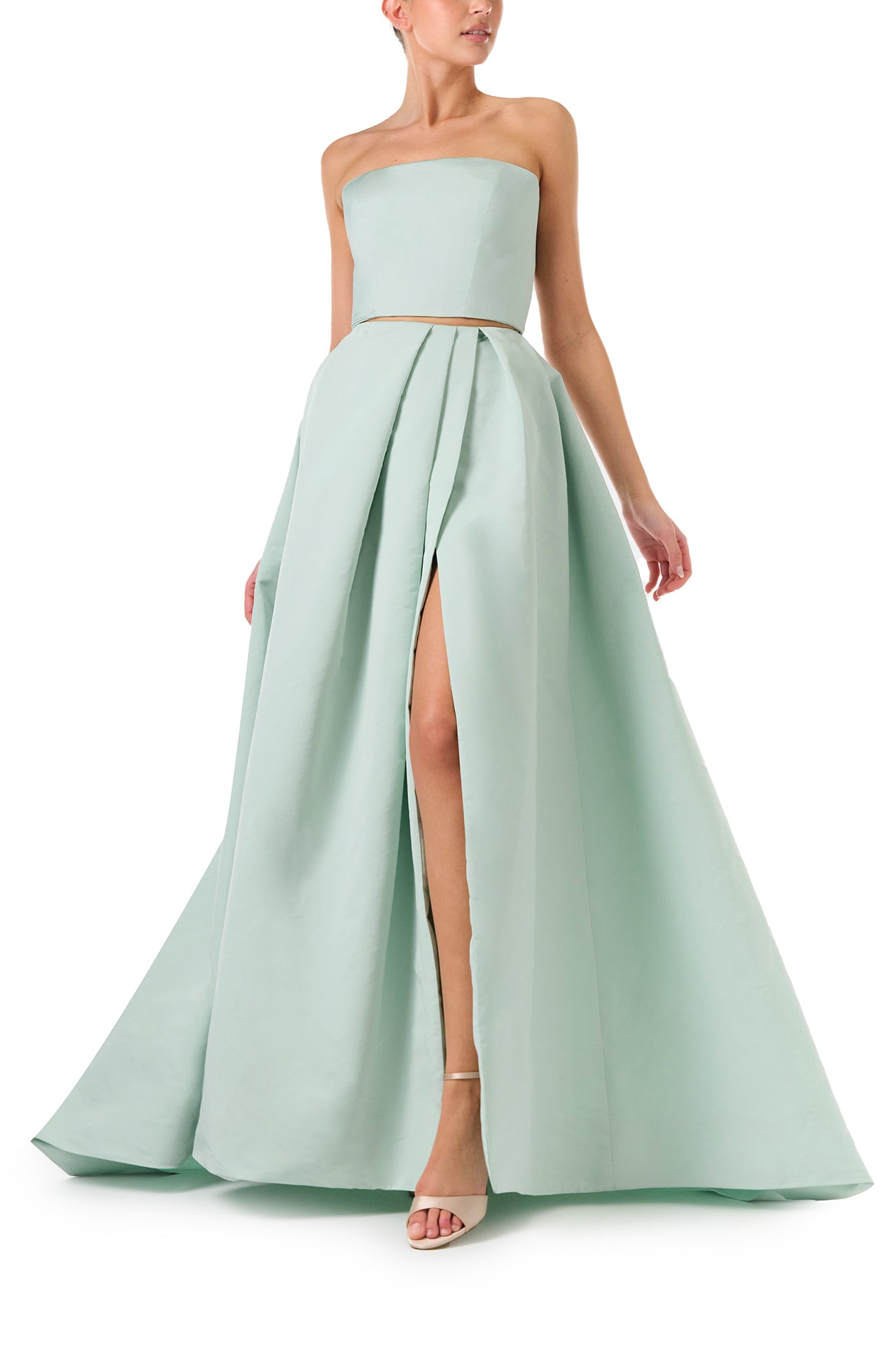 Monique Lhuillier Spring 2023 ball skirt with front slit in pistachio silk faille fabric - front with slit.