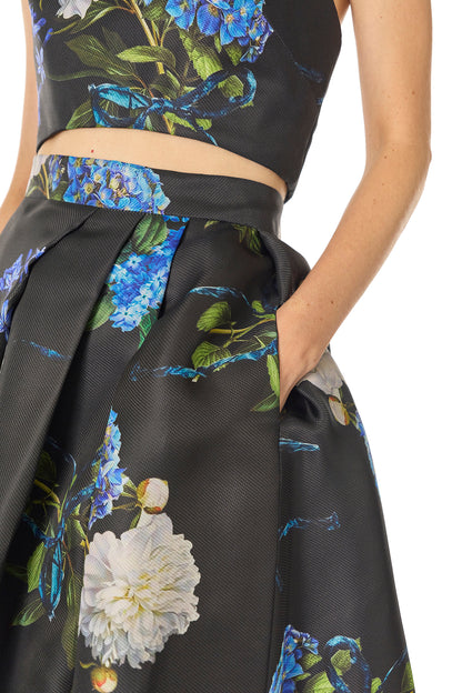 Monique Lhuillier Fall 2024 Pleated ball skirt with pockets and high front leg slit in Night Sky Hydrangea Printed Gazar - pockets.