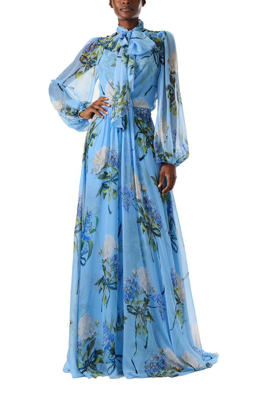Monique Lhuillier Fall 2024 long sleeve gown in blue floral printed chiffon with self-tie neckline - front.