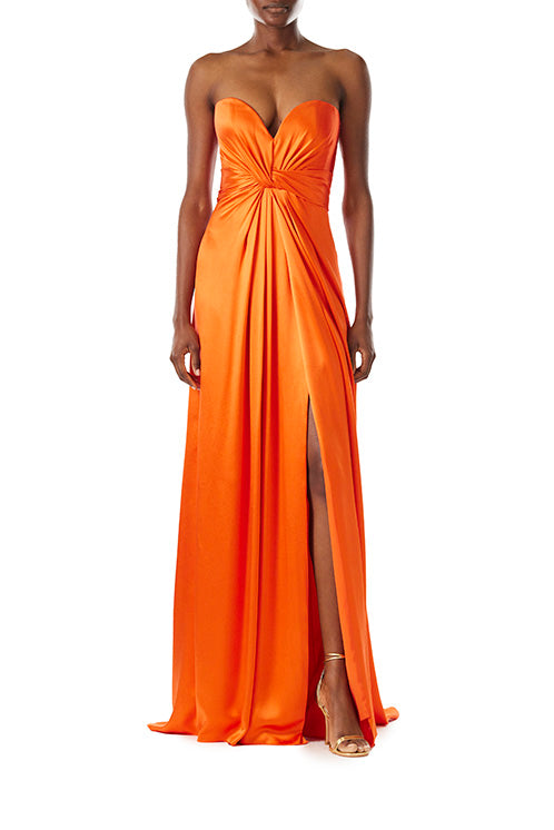 Monique Lhuillier strapless poppy red satin gown with twist bodice and high front slit.