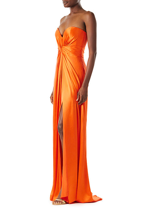 Monique Lhuillier strapless poppy red satin gown with twist bodice and high front slit.