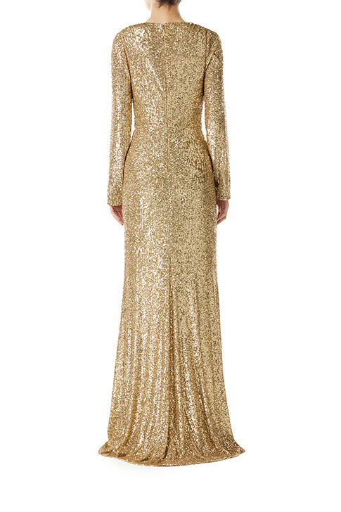 Monique Lhuillier long sleeve gown with deep v-neck and knot detail at waist in gold mini stretch sequin fabric.