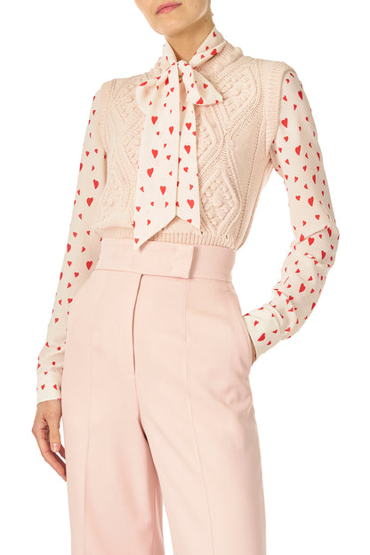 Monique Lhuillier Sleeveless, bobble crop tank in Pale Blush wool cable knit - front with heart print blouse underneath.