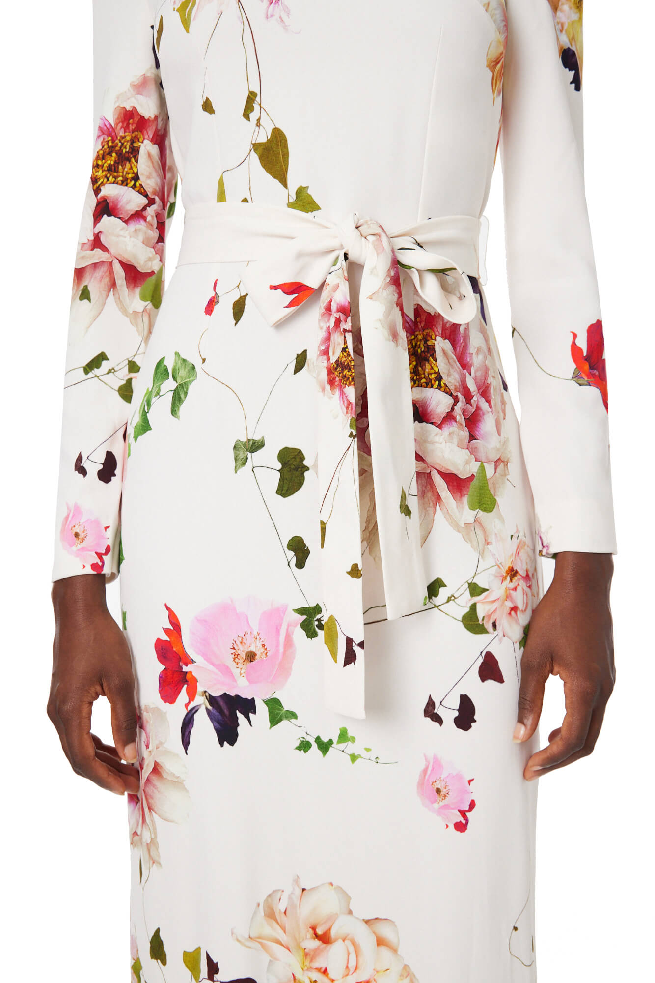 Monique Lhuillier jewel neck, tea-length gown with long sleeves and self-tie sash in silk white floral fabric.