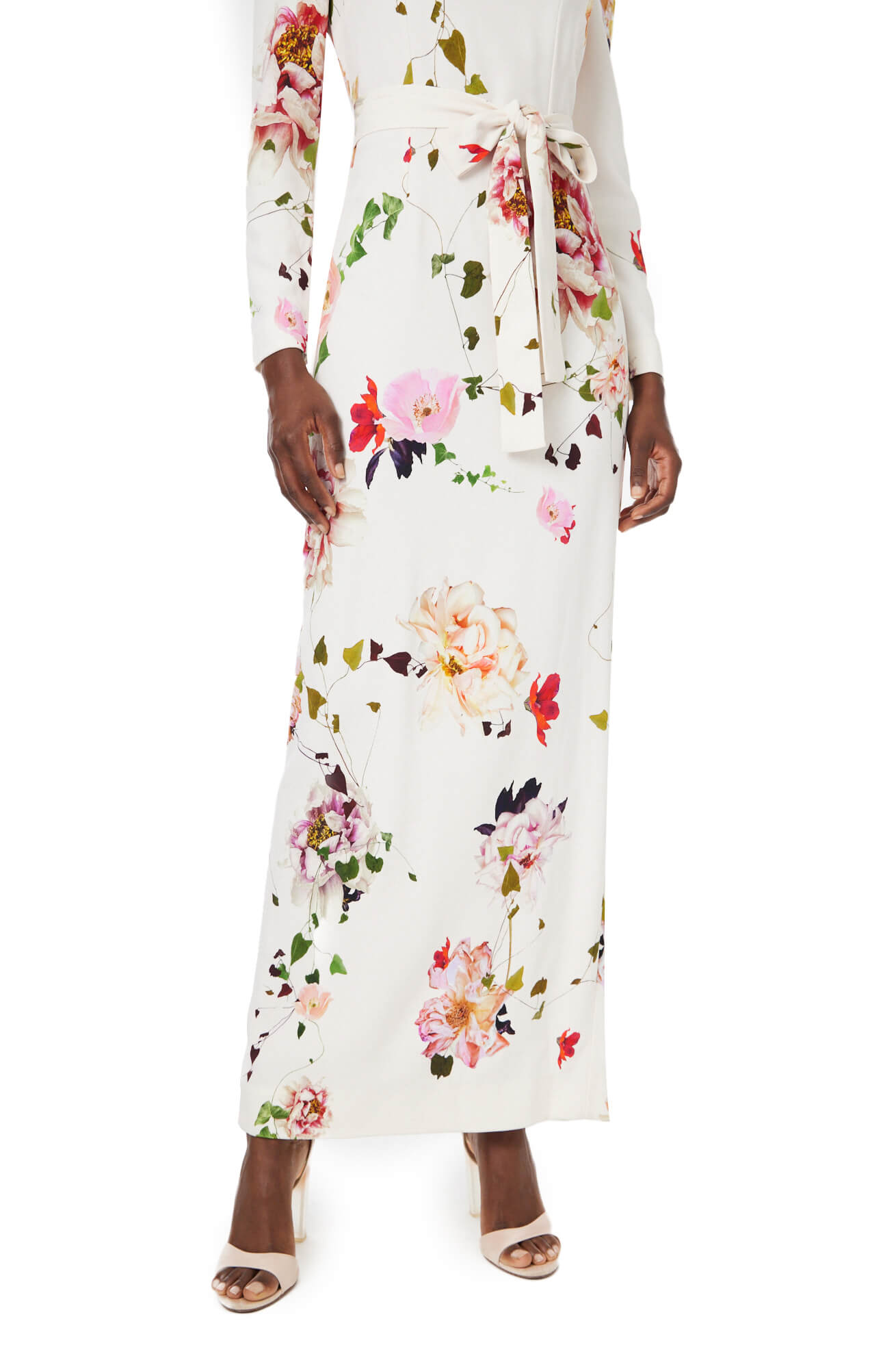 Monique Lhuillier jewel neck, tea-length gown with long sleeves and self-tie sash in silk white floral fabric.