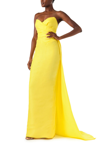 Monique Lhuillier Spring 2024 yellow strapless gown with sweetheart neckline and train - left side.