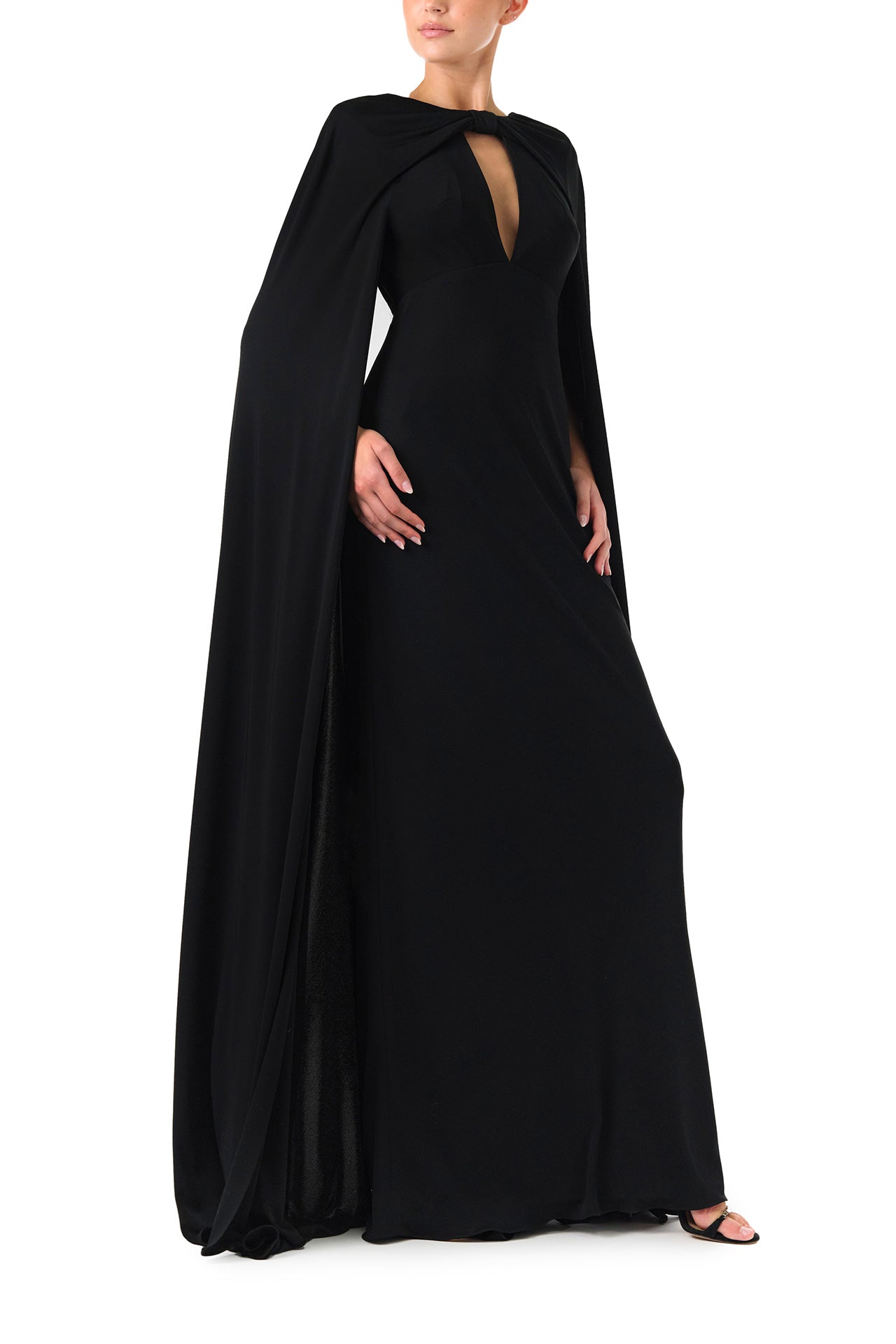 Monique Lhuillier Spring 2024 black crepe-back satin gown with attached cape and keyhole bodice - right side.