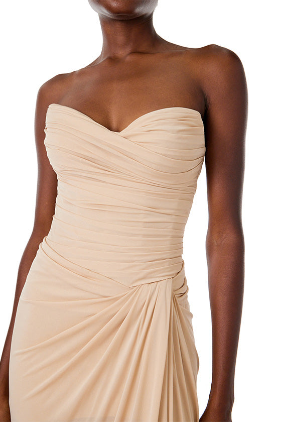 Monique Lhuillier strapless floor length gown with sweetheart neckline and high front leg slit in sand colored matte jersey fabric.
