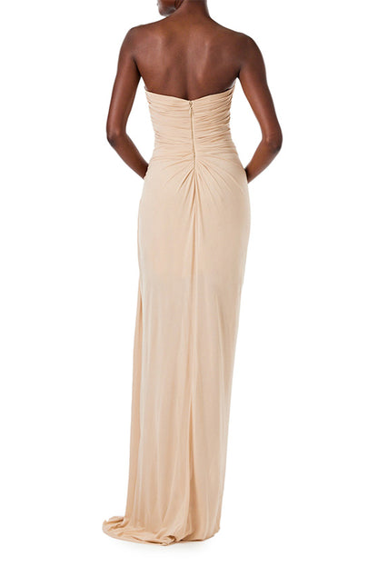 Monique Lhuillier strapless floor length gown with sweetheart neckline and high front leg slit in sand colored matte jersey fabric.