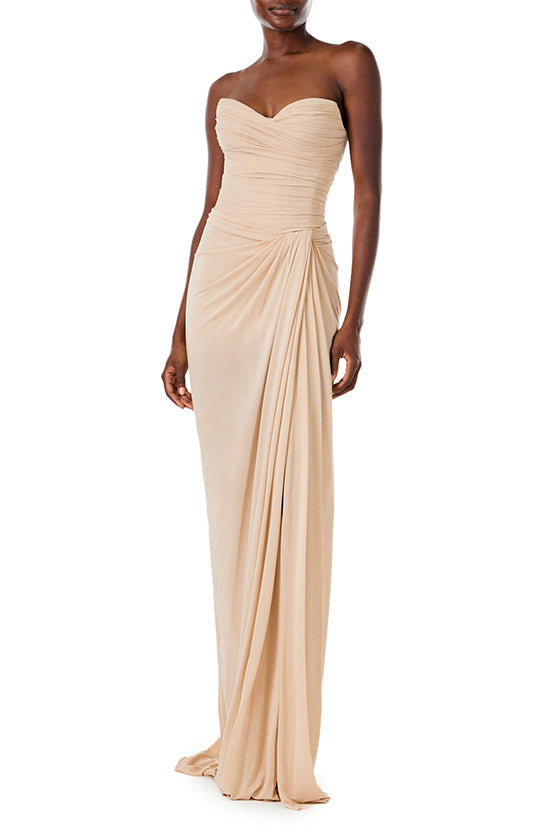 Monique Lhuillier strapless floor length gown with sweetheart neckline and high front leg slit in sand colored matte jersey fabric.