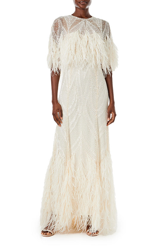 Monique Lhuillier Spring 2024 embroidered capelet gown with feathered trim.