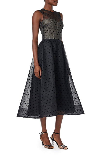 Monique Lhuillier noir dotted tulle, sleeveless jewel neck cocktail dress with caged skirt.