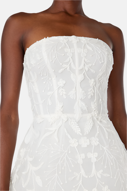 Monique Lhuillier Spring 2024 strapless, embroidered cocktail dress with structured skirt.