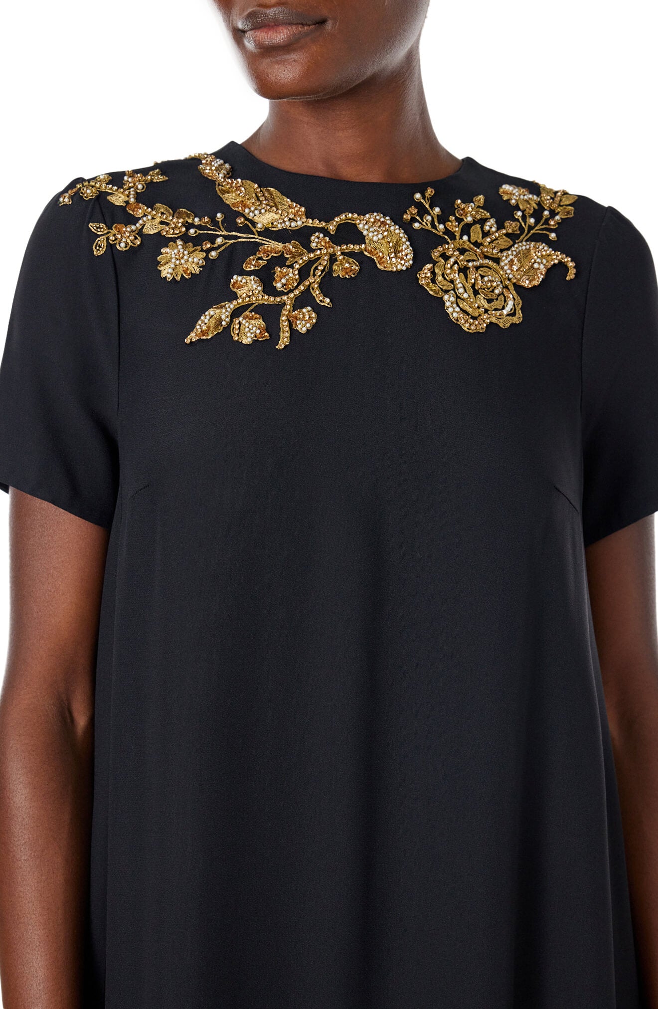 Monique Lhuillier black jewel neck, short sleeve caftan with gold embroidery.