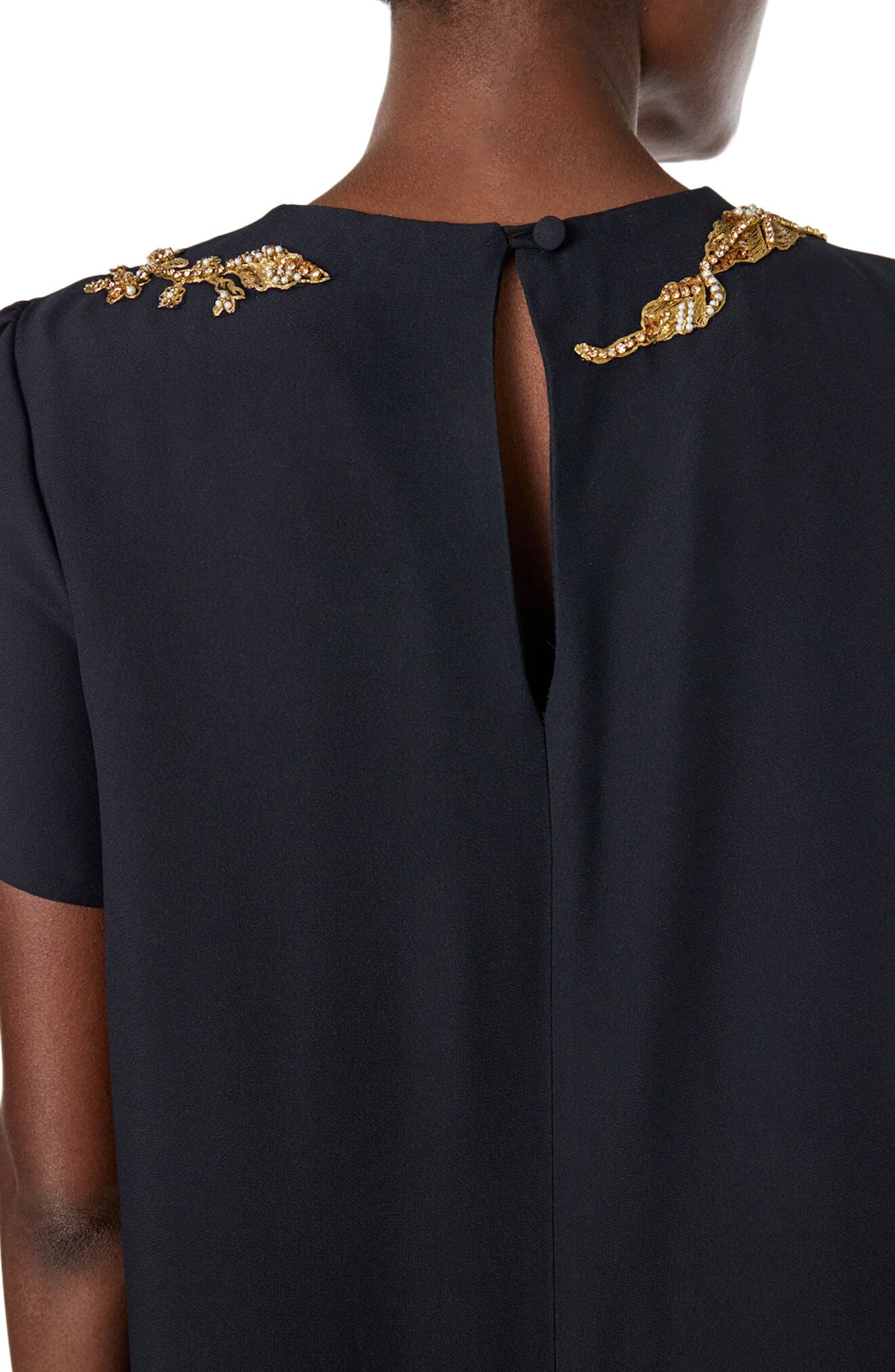 Monique Lhuillier black jewel neck, short sleeve caftan with gold embroidery.