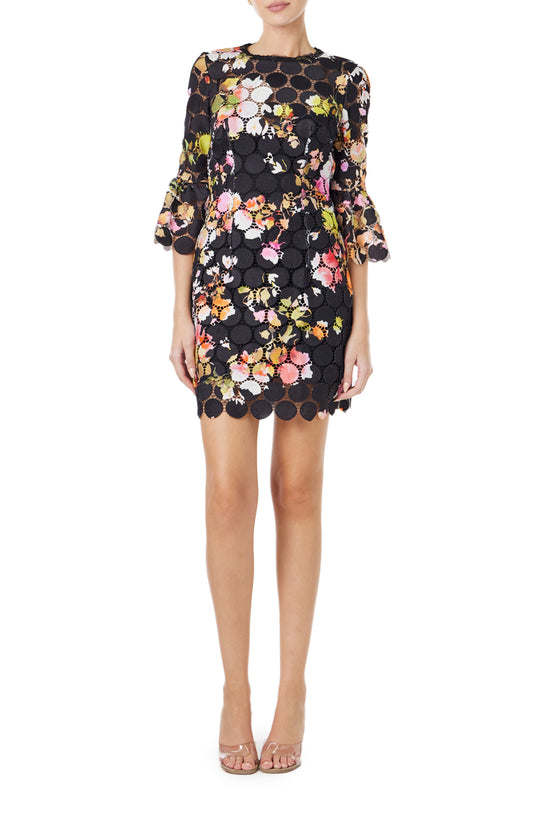 Monique Lhuillier Spring 2024 jewel neck mini dress in black/floral printed circle lace with bracelet length bell sleeves - front.