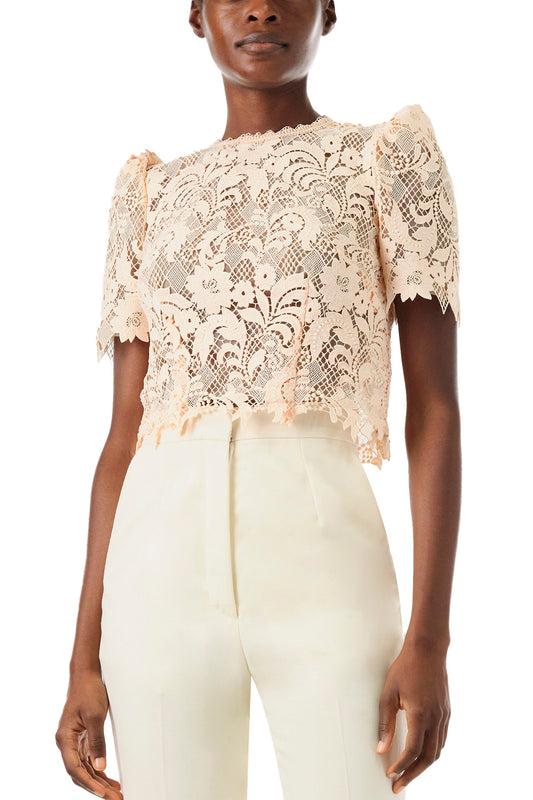 Monique Lhuillier Spring 2024 blush lace short sleeve, jewel neck lace top with sculpted shoulder and lace scallop detailing - front detail.