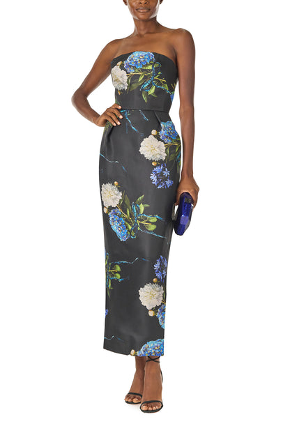 Monique Lhuillier Fall 2024 strapless, tea length gown with tulip skirt and pockets in Night Sky Hydrangea printed Gazar - front with Dasha handbag.