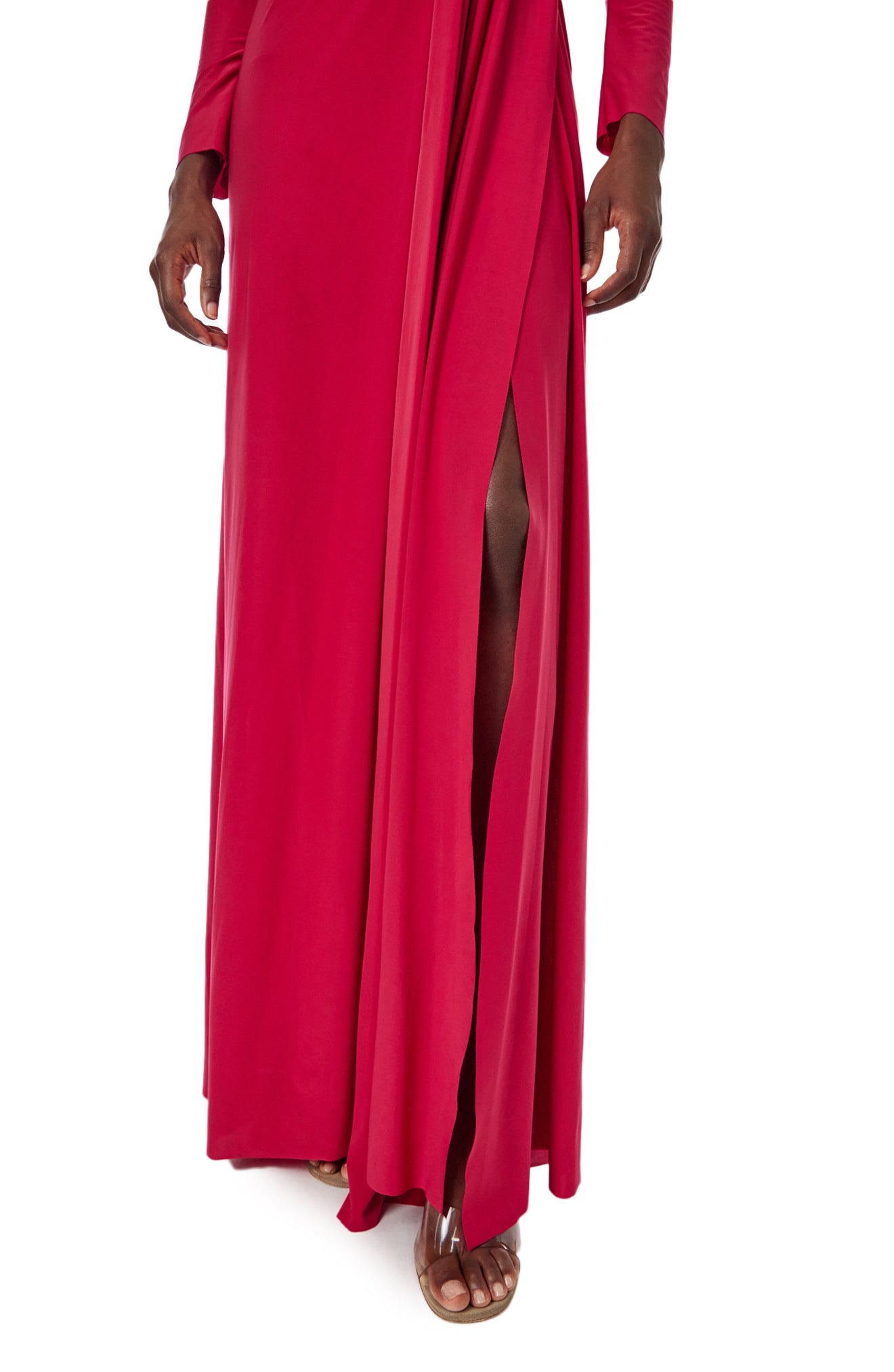 Monique Lhuillier Spring 2024 scarlet red matte jersey long sleeve, gown with draped bodice, jewel neckline and high front skirt slit - slit.