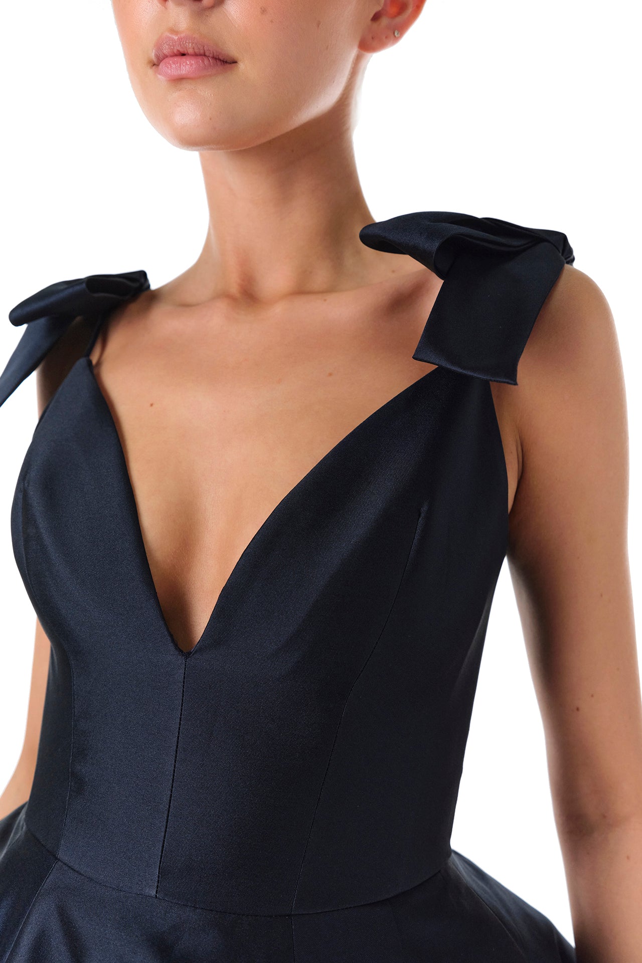 Monique Lhuillier Fall 2024 deep V-neck ball gown in navy mikado with full skirt and bow detail at shoulders - bow details.