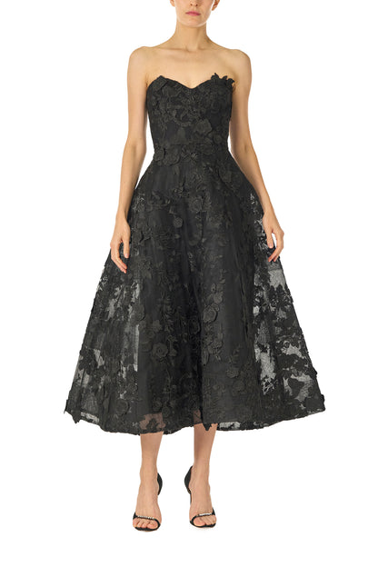 Monique Lhuillier Fall 2024 tea-length, strapless dress in noir 3D lace with full skirt and fitted sweetheart bodice - front.