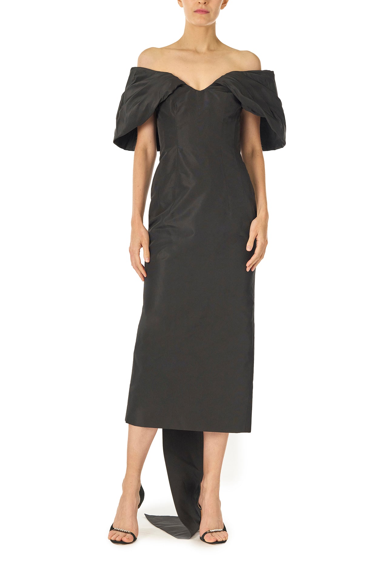 Monique Lhuillier Fall 2024 Off-the-shoulder tea length column dress with draped neckline and train in noir silk faille - front.