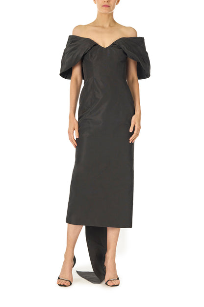 Monique Lhuillier Fall 2024 Off-the-shoulder tea length column dress with draped neckline and train in noir silk faille - front.