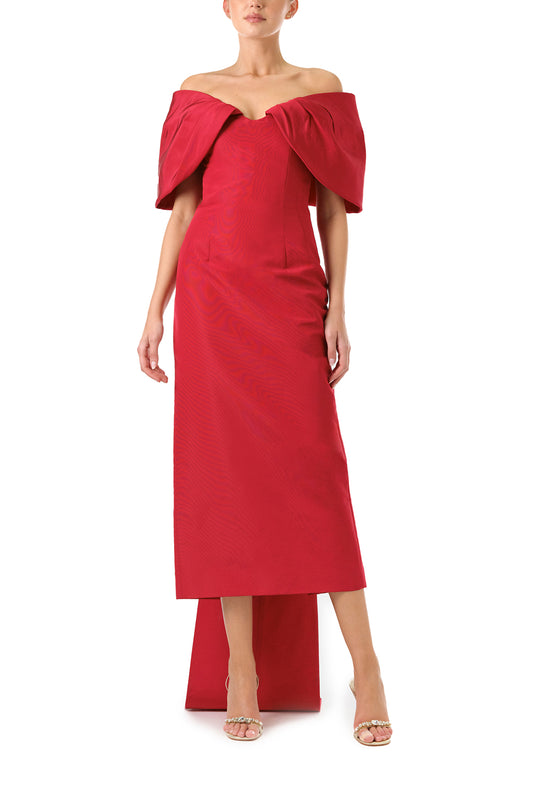 Monique Lhuillier Fall 2024 off-the-shoulder tea length column dress with draped neckline and bow-train in pomegranate silk faille - front.