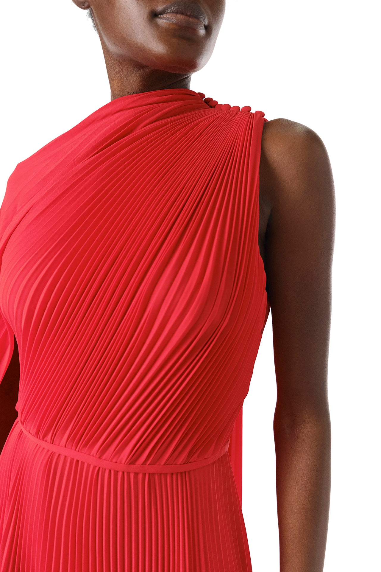 Monique Lhuillier Fall 2024 One shoulder gown with attached, asymmetric-pleated cape in Scarlet Georgette - detail.