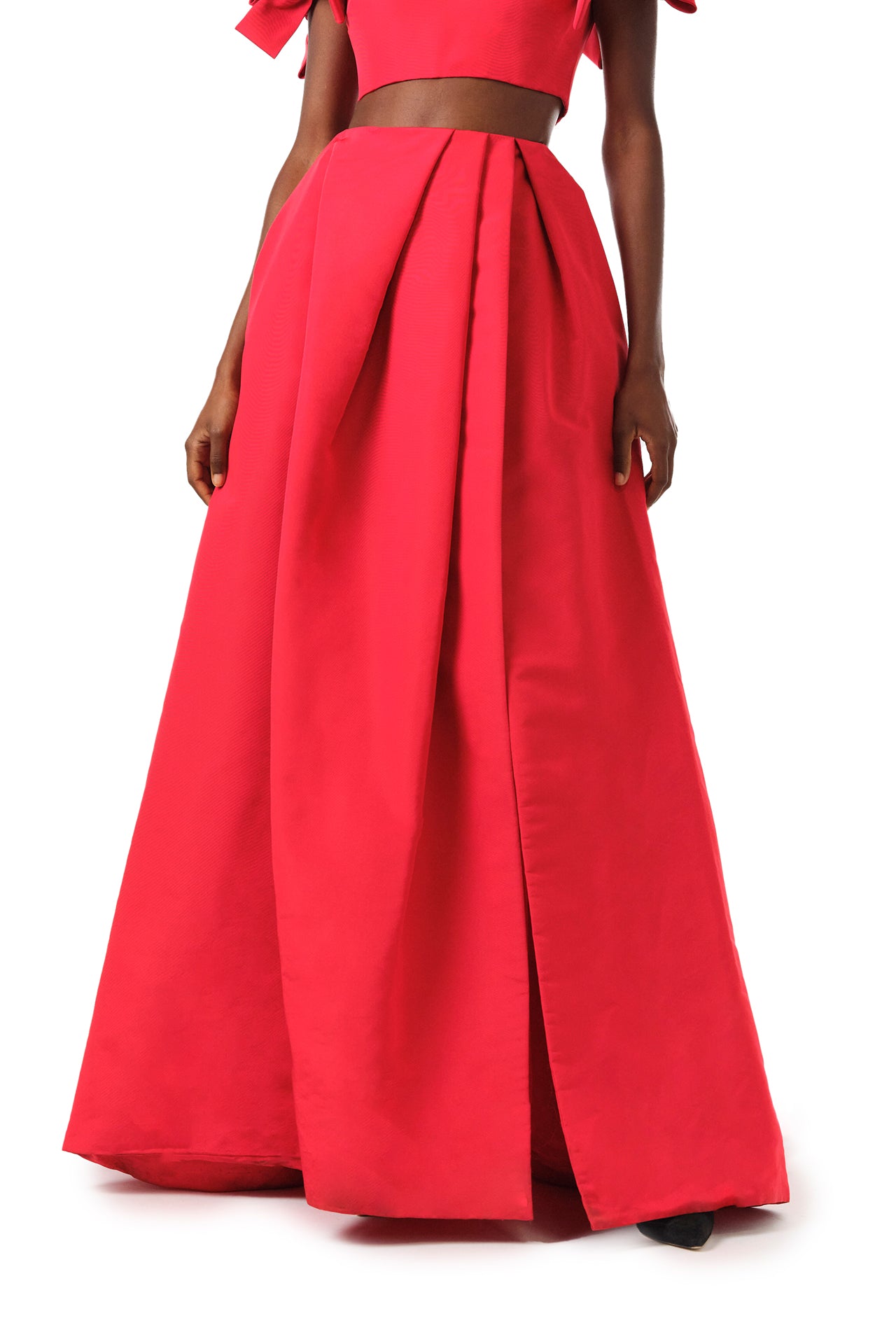 Monique Lhuillier Fall 2024 scarlet red faille pleated ballgown skirt with high front slit and pockets - front crop.