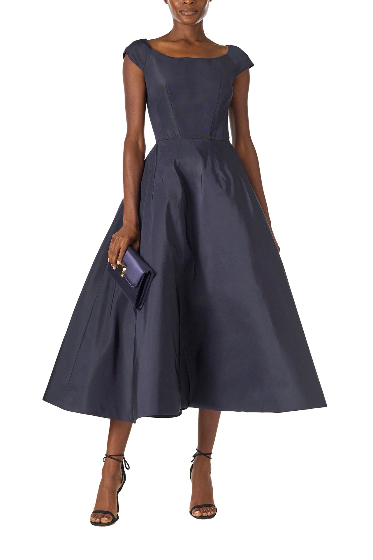 Monique Lhuillier Fall 2024 Bateau neck, cap sleeve dress with full tea length skirt in night sky silk faille - front with Delphine satin clutch.
