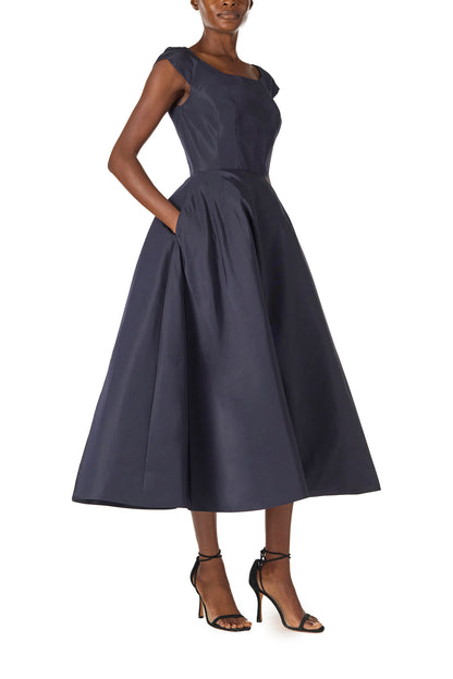 Monique Lhuillier Fall 2024 Bateau neck, cap sleeve dress with full tea length skirt in night sky silk faille - side with pockets.