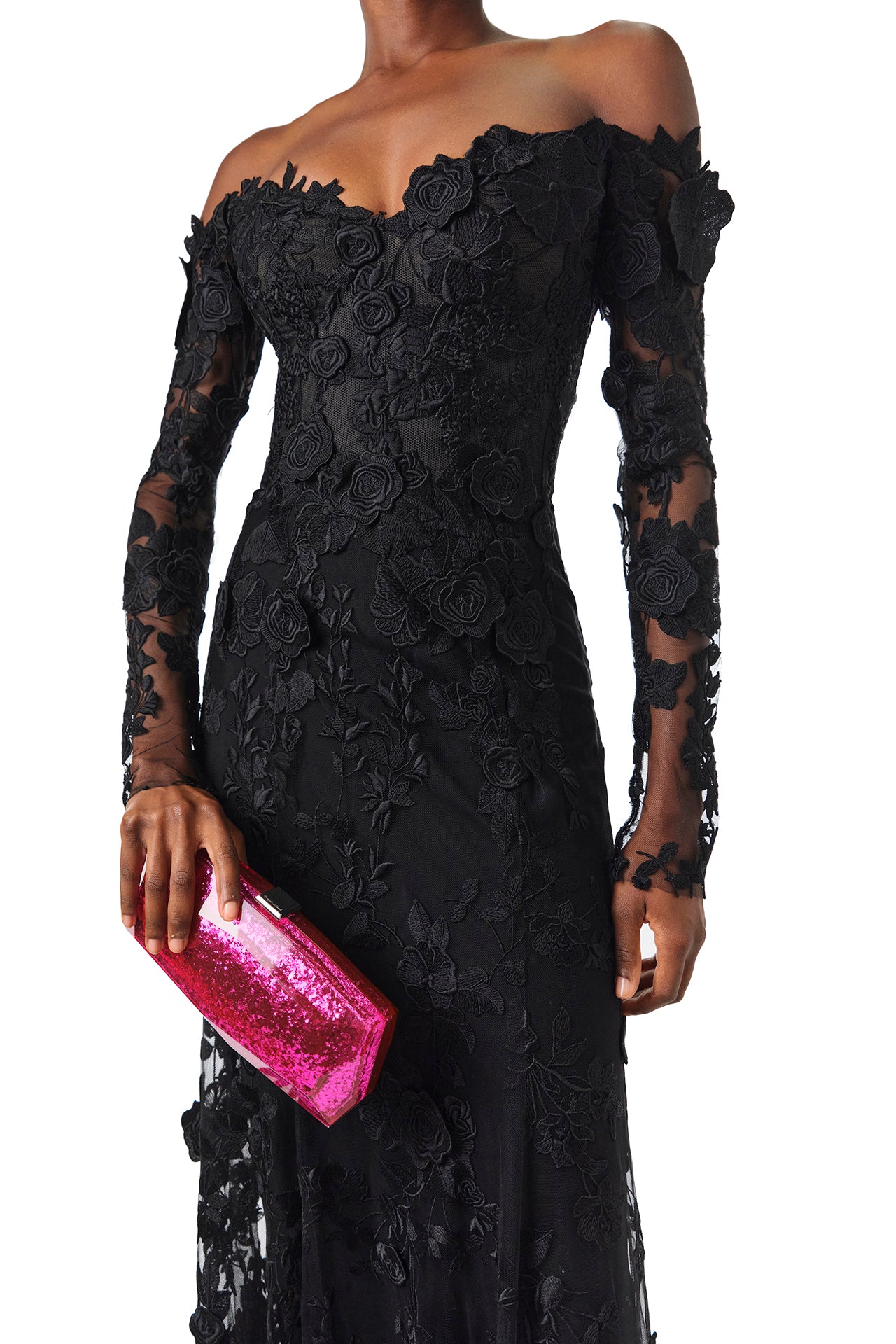 Monique Lhuillier Fall 2024 Long sleeve black lace trumpet gown with off-the-shoulder sweetheart neckline and unlined sleeves - front with fuchsia handbag.