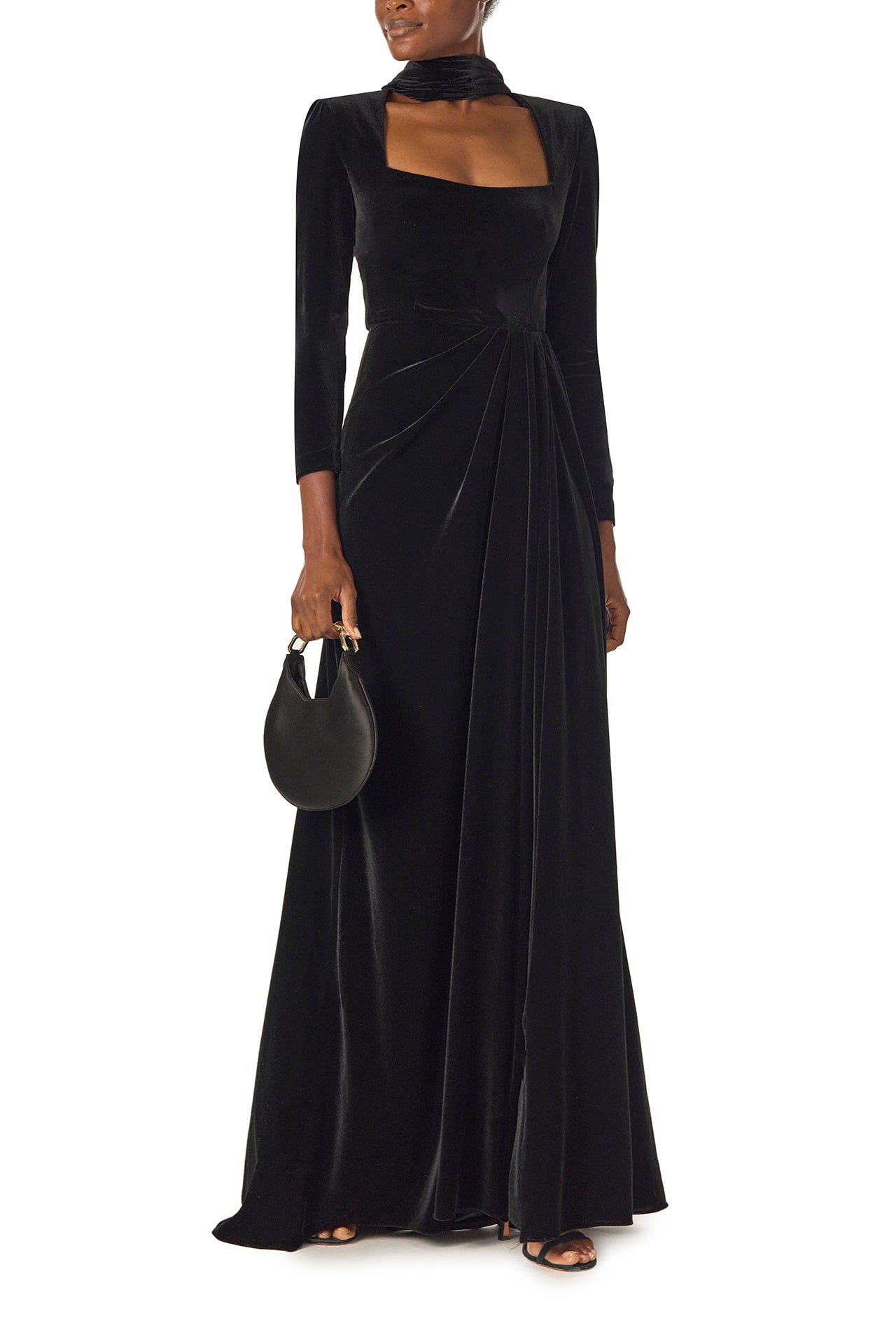 Monique Lhuillier Fall 2024 long sleeve gown with square neckline, front skirt draping and detached neck scarf in noir stretch velour - front with Demi bag.