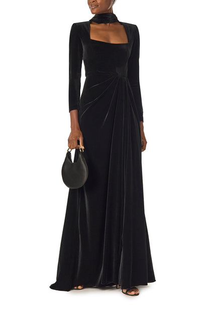 Monique Lhuillier Fall 2024 long sleeve gown with square neckline, front skirt draping and detached neck scarf in noir stretch velour - front with Demi bag.