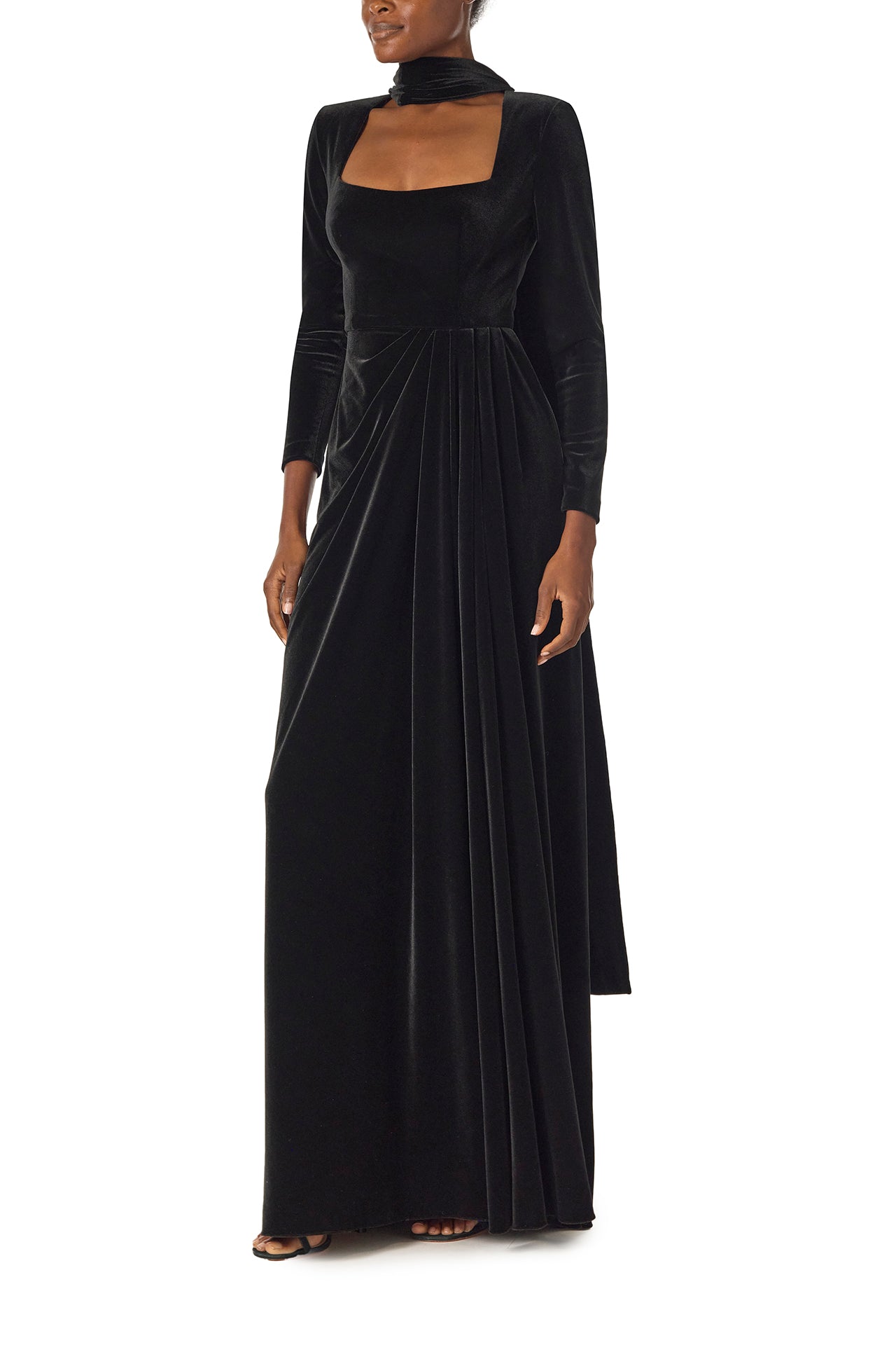 Monique Lhuillier Fall 2024 long sleeve gown with square neckline, front skirt draping and detached neck scarf in noir stretch velour - left side.