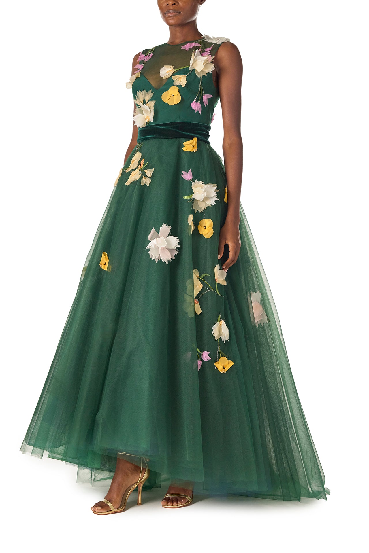 Monique Lhuillier Fall 2024 sleeveless, green tulle gown with floral embroidery, illusion neckline, full A-line skirt and velvet cummerbund at waist - left side.