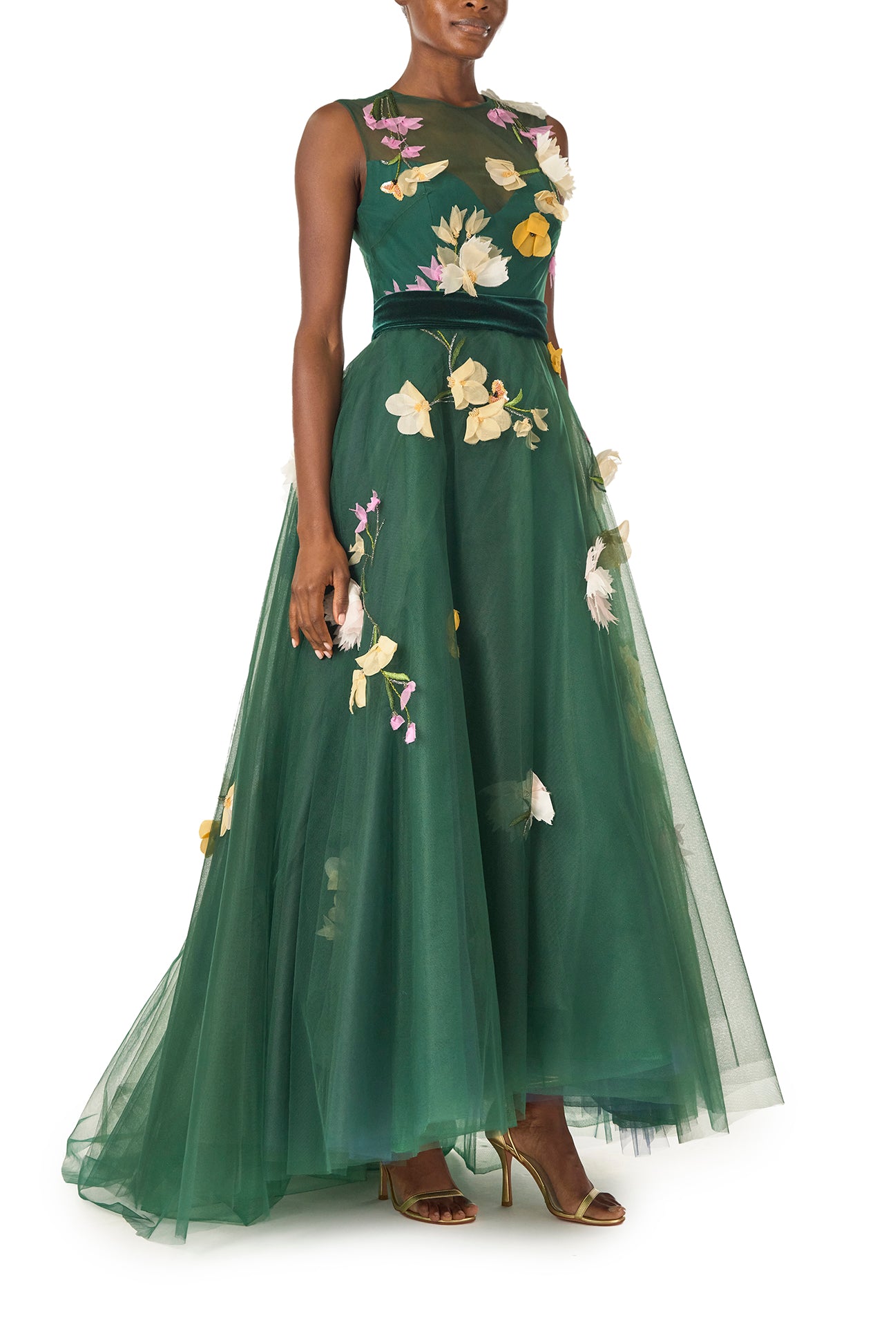Monique Lhuillier Fall 2024 sleeveless, green tulle gown with floral embroidery, illusion neckline, full A-line skirt and velvet cummerbund at waist - right side.