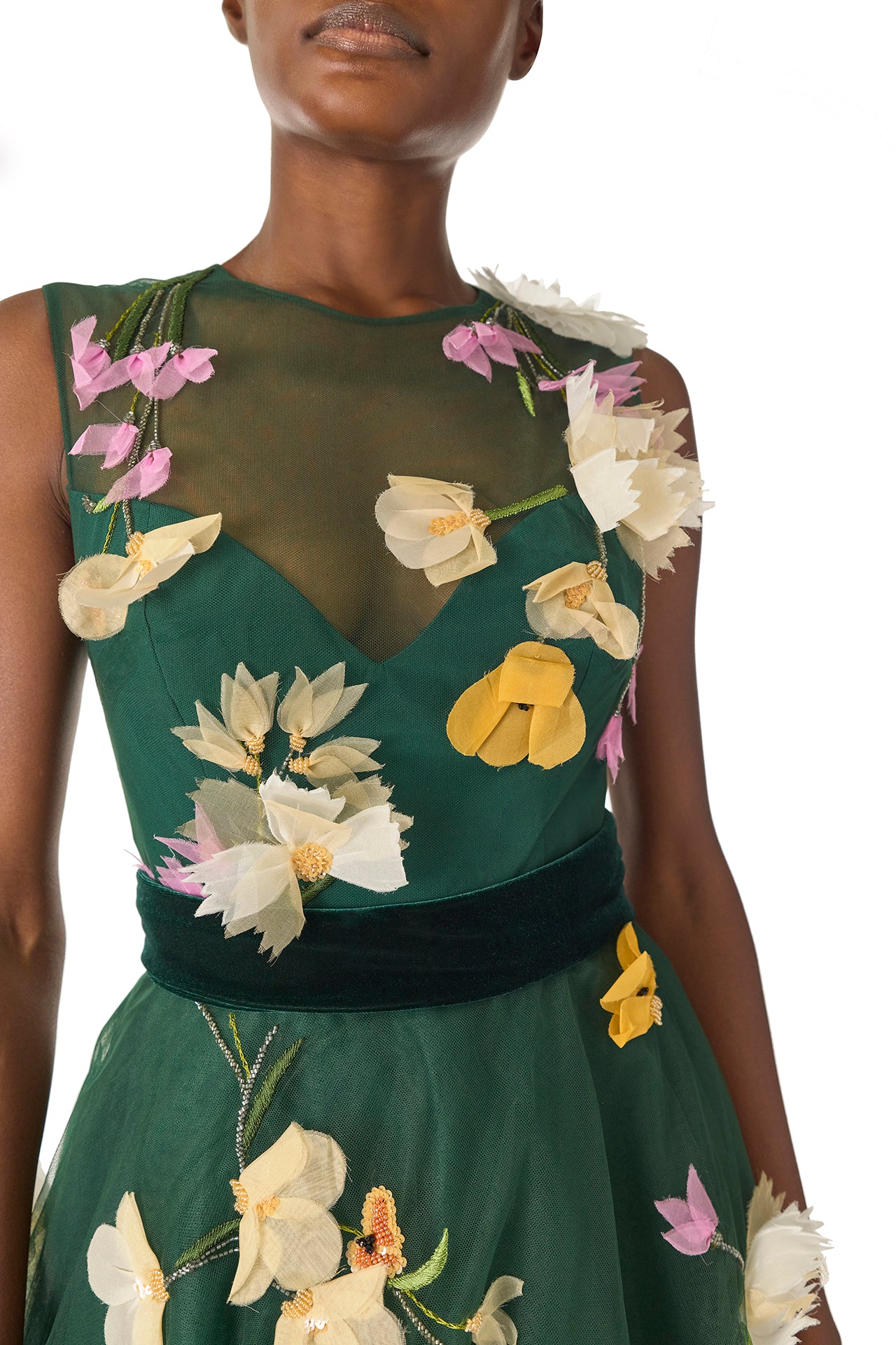 Monique Lhuillier Fall 2024 sleeveless, green tulle gown with floral embroidery, illusion neckline, full A-line skirt and velvet cummerbund at waist - neckline.