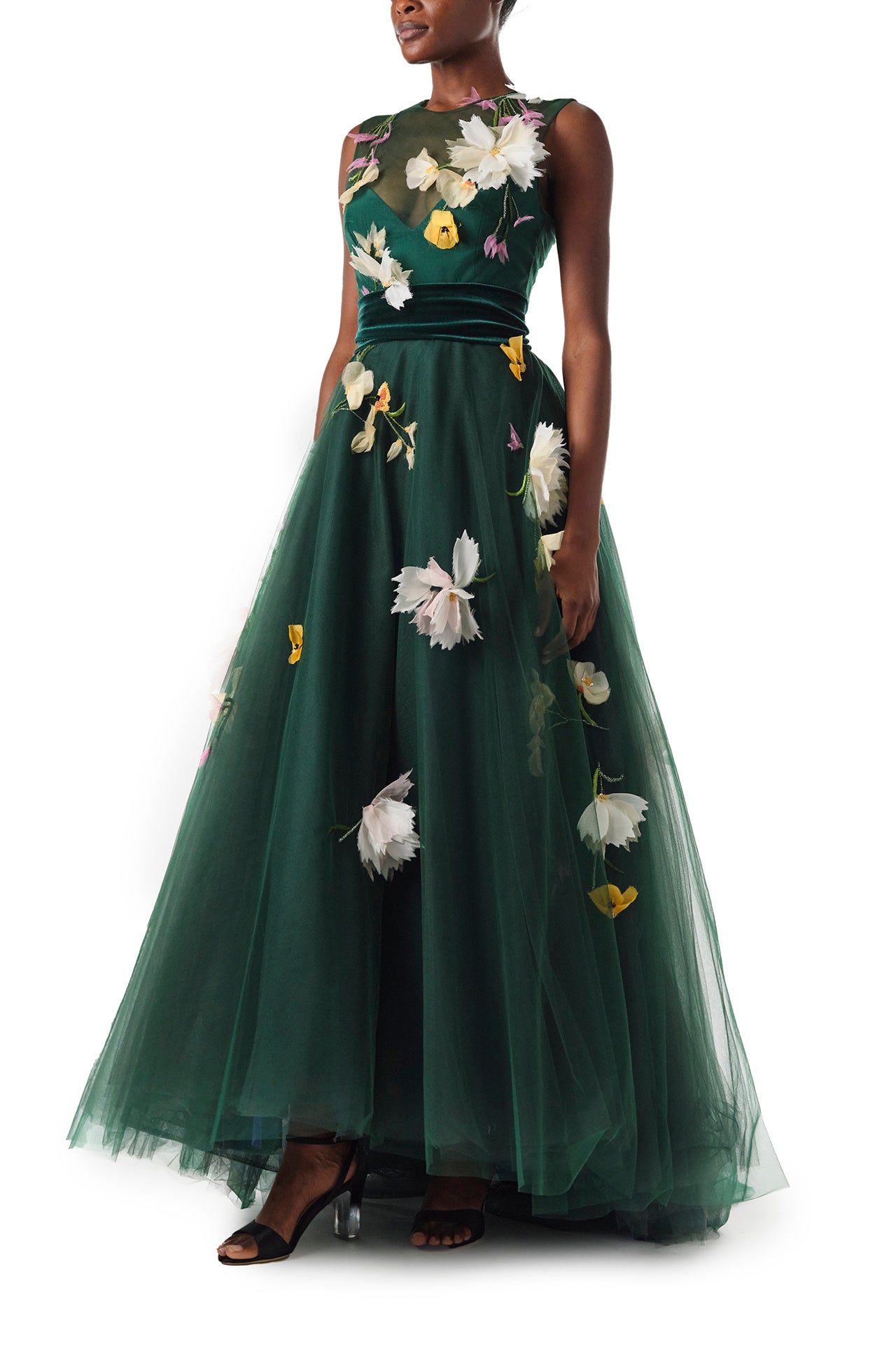 Monique Lhuillier Fall 2024 sleeveless, green tulle gown with floral embroidery, illusion neckline, full A-line skirt and velvet cummerbund at waist - left side.