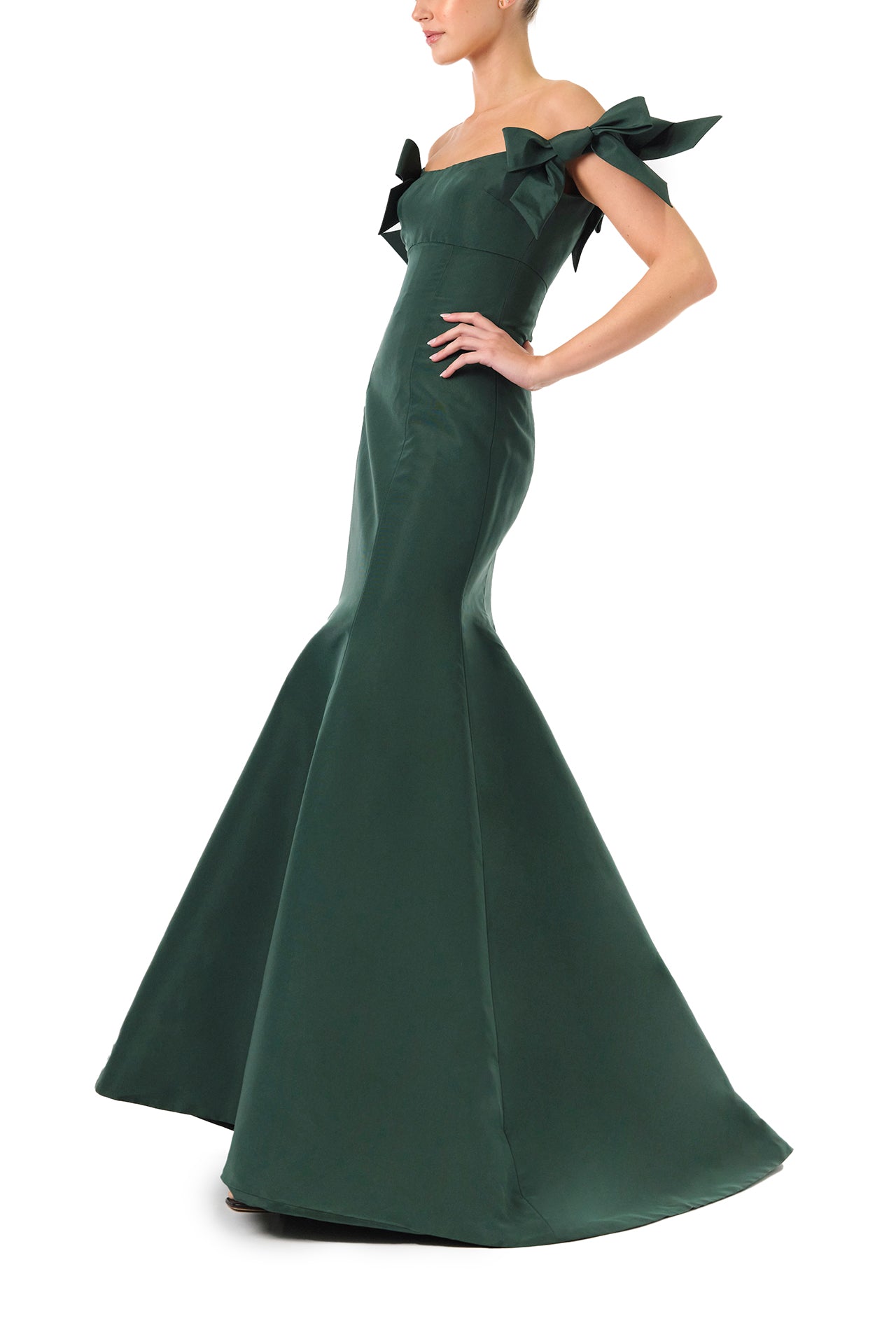 Monique Lhuillier Fall 2024 off the shoulder gown with trumpet skirt and bow sleeves in Juniper green faille fabric - left side.