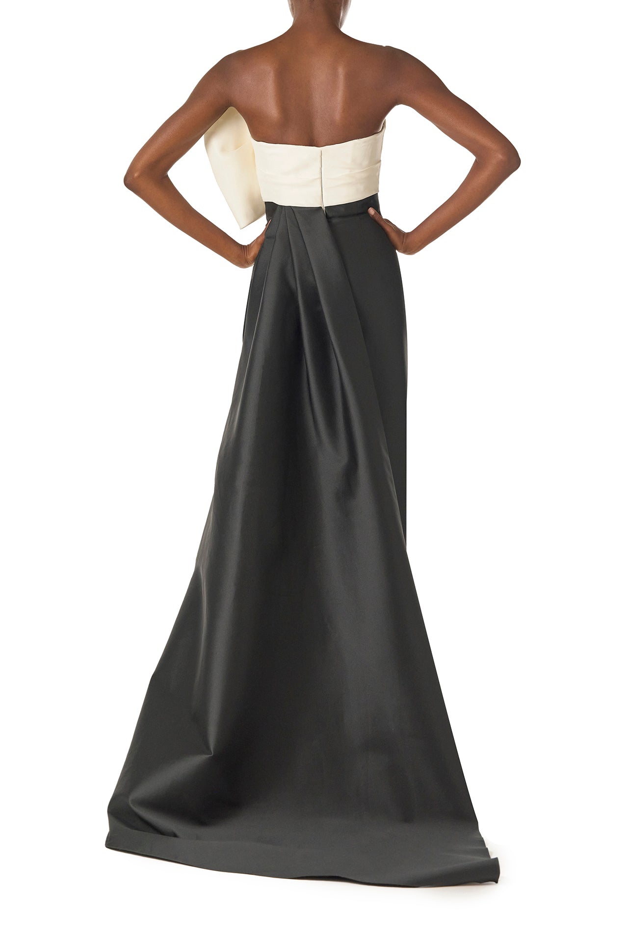 Monique Lhuillier Spring 2025 Strapless column gown with asymmetric draped bow neckline and pleated back train in Noir + Silk White Mikado - back.
