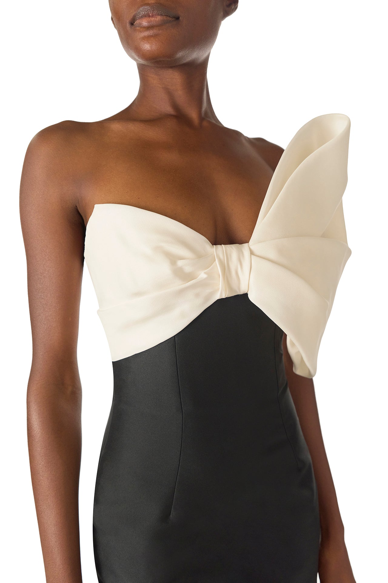 Monique Lhuillier Spring 2025 Strapless column gown with asymmetric draped bow neckline and pleated back train in Noir + Silk White Mikado - bow neckline.