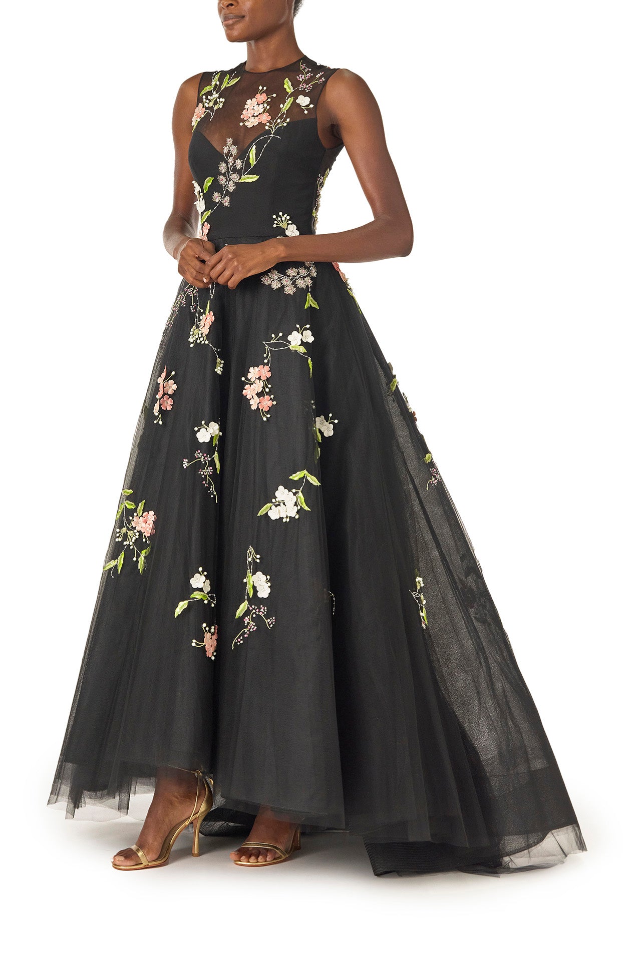 Monique Lhuillier Spring 2025 Sleeveless, noir tulle gown with floral embroidery and slight high-low hem - left side.