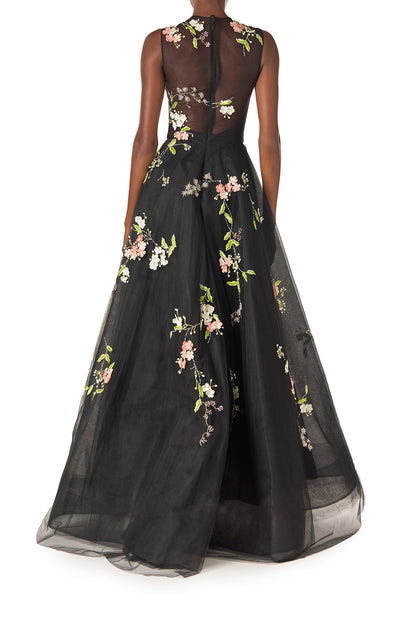 Monique Lhuillier Spring 2025 Sleeveless, noir tulle gown with floral embroidery and slight high-low hem - back.