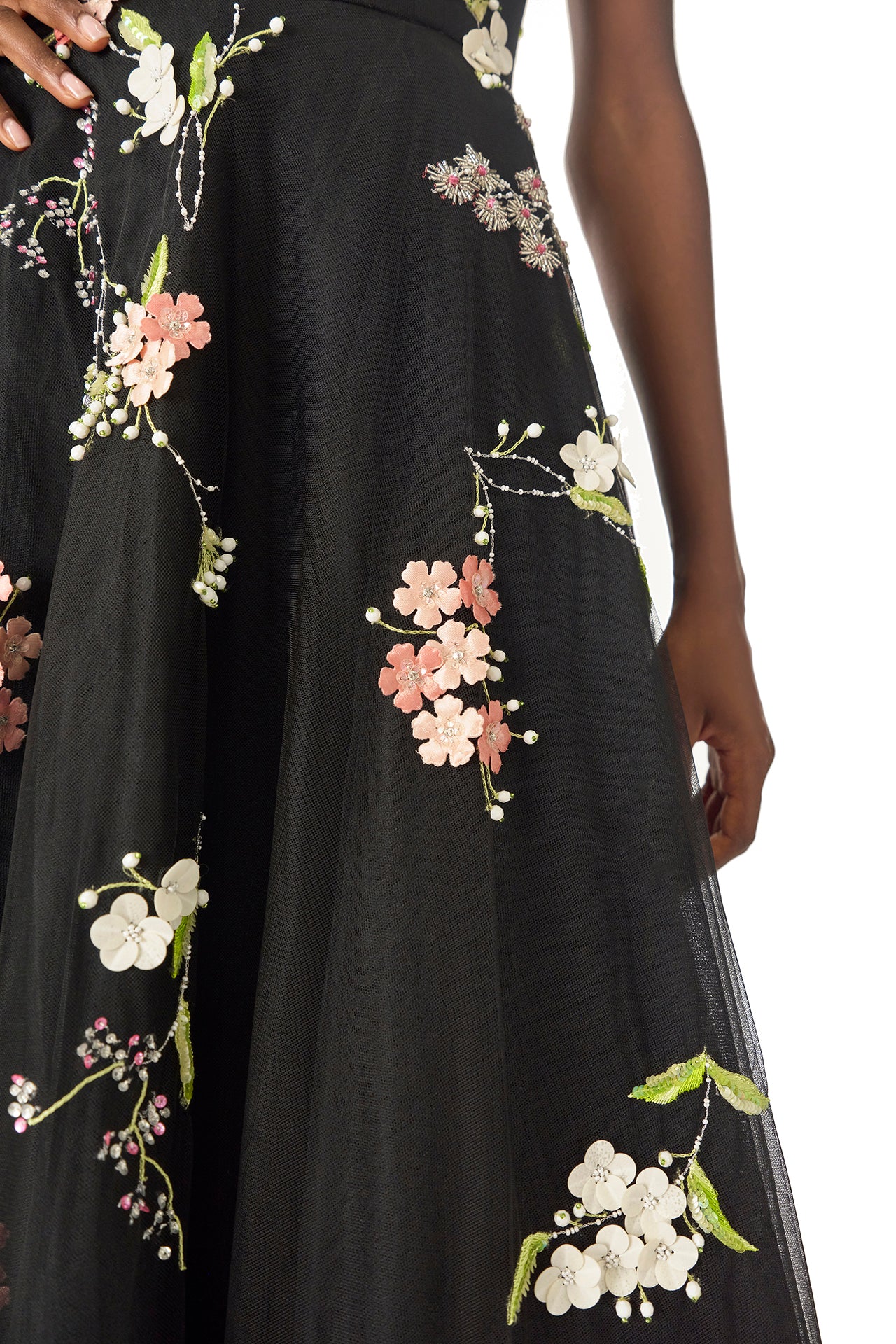 Monique Lhuillier Spring 2025 Sleeveless, noir tulle gown with floral embroidery and slight high-low hem - fabric.