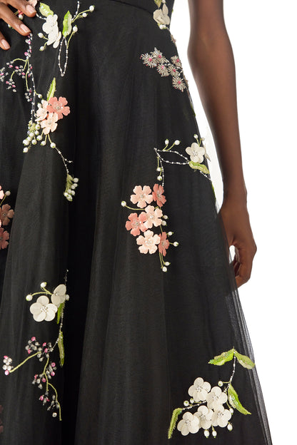 Monique Lhuillier Spring 2025 Sleeveless, noir tulle gown with floral embroidery and slight high-low hem - fabric.