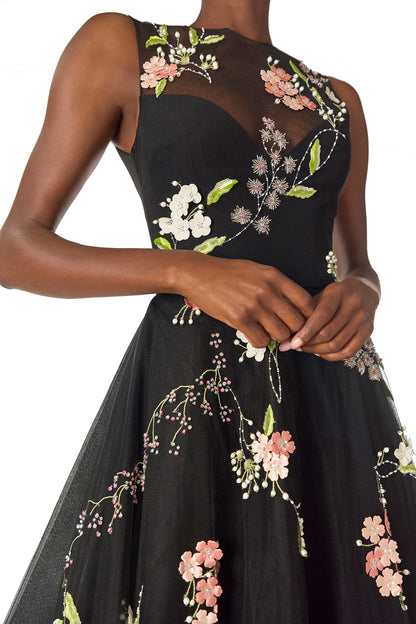 Monique Lhuillier Spring 2025 Sleeveless, noir tulle gown with floral embroidery and slight high-low hem - detail two.